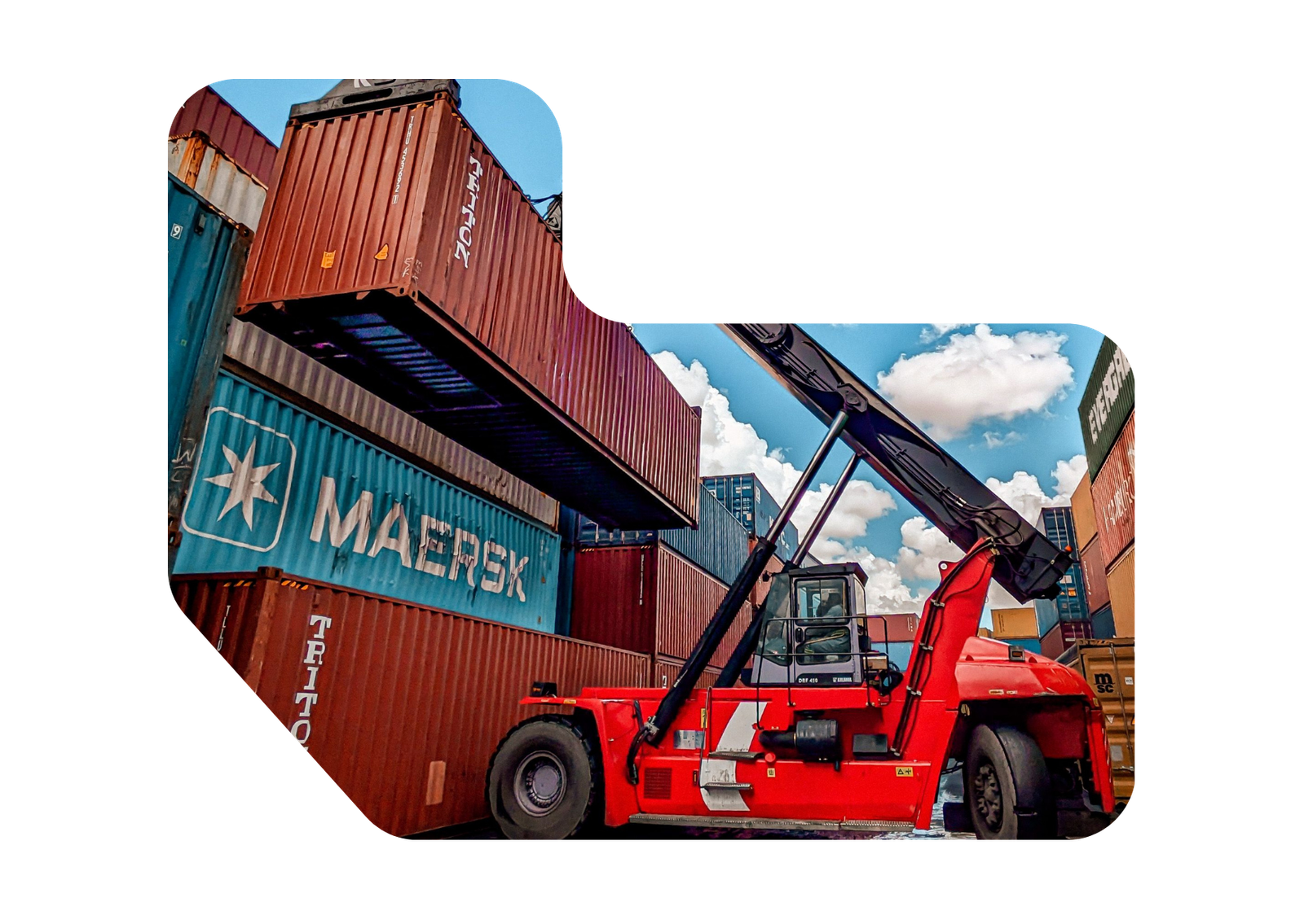 Reach stacker lifting a shipping container at the freight yard
